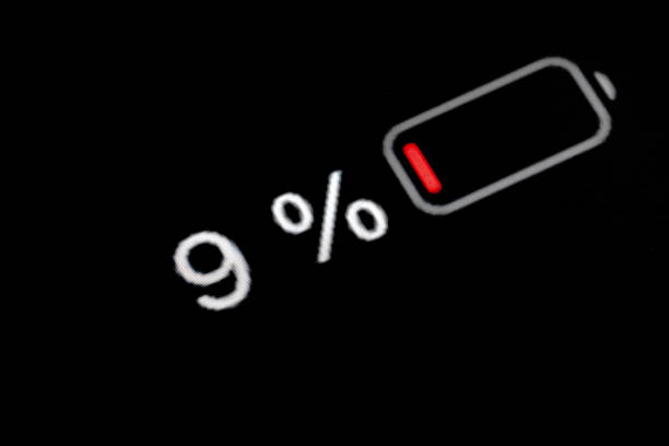 Low level of smartphone charged battery level indicator - nine, 9 percent: close up macro view of gadget display, screen. Energy, technology, power, digital and symbol concept