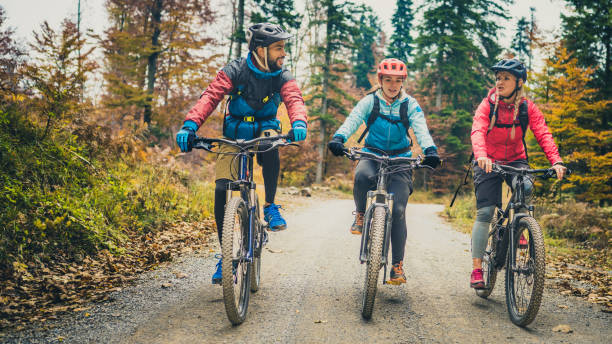 istock Satisfied young people riding mountain bikes and chatting. 1415985264