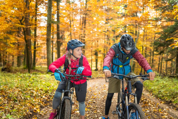 istock Couple of bikers standing on path and resting 1415985270