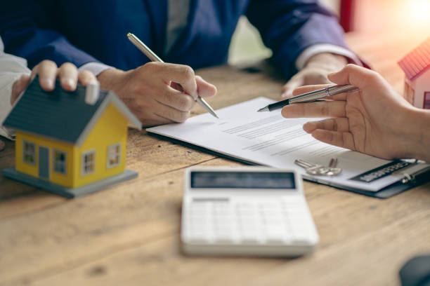 istock A sales representative is discussing the details before the customer agrees to sign a contract. by explaining the details and terms and conditions of the rental real estate concept 1415985669