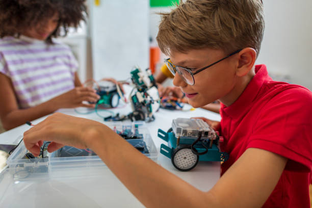 istock Children students building robotic cars at STEM class 1415989411