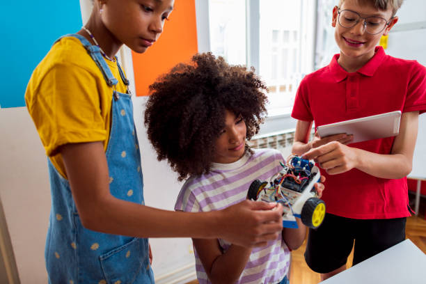 Children students building robotic cars at STEM class stock photo