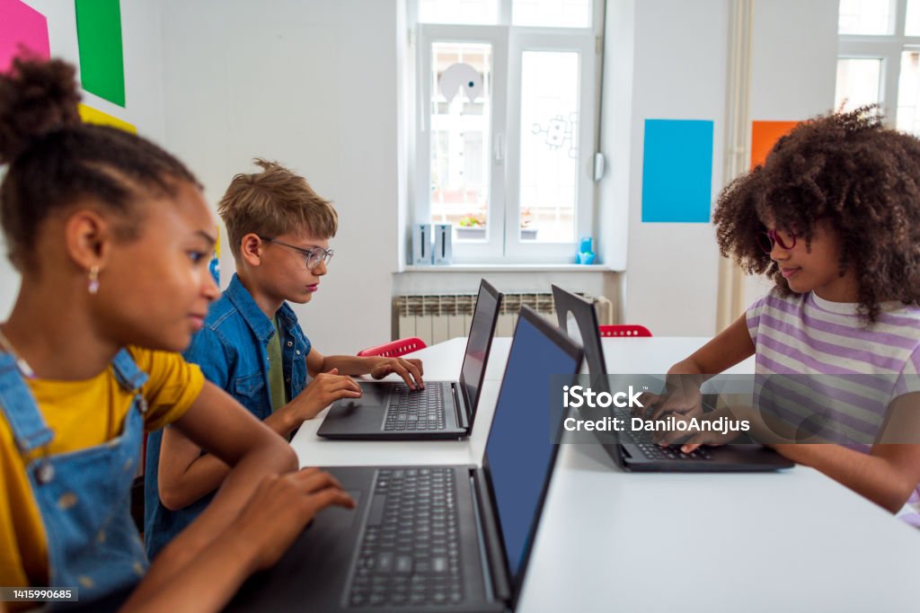 Young Students Learn About Coding In Elementary School Stock Photo Young students learn about coding in elementary school stock photo