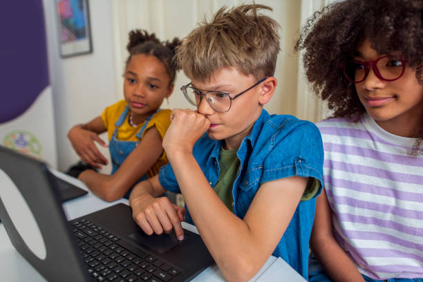 Young students learn about coding in elementary school stock photo