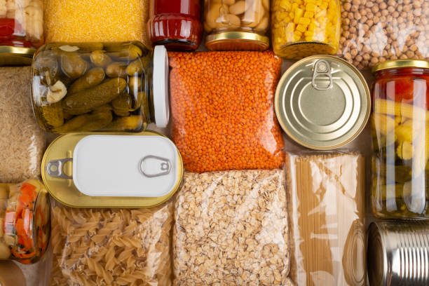 istock Emergency survival groceries on kitchen table closeup flat lay 1415994218