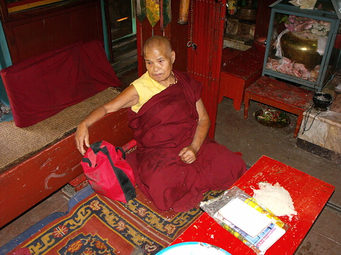 Patan, Kathmandu, Nepal, August 20, 2011: Buddhist monk inside Hiranya Varna Mahavihar. Golden Temple. Patan, Kathmandu. Nepal
