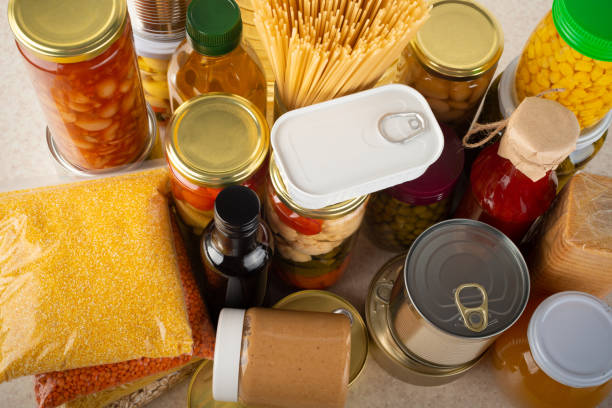 istock Emergency survival food set on white kitchen table high angle view 1415994261