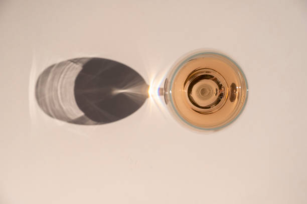 istock Still life scene with wine glasses on beige background in sunlight with harsh shadows. Abstract drinking wine concept. 1415994309