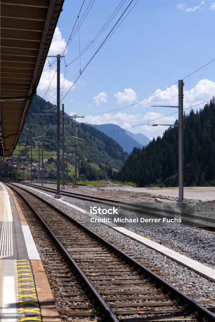 Platform at railway station of mountain village Airolo, Canton Ticino, on a sunny summer day. Photo taken July 3rd, 2022, Airolo, Switzerland. Airolo Stock Photo