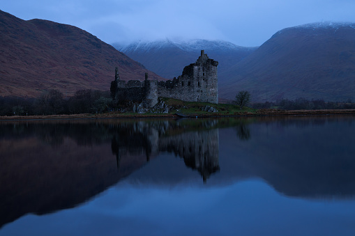 Kilchurn castle at dawn with reflection on loch awe