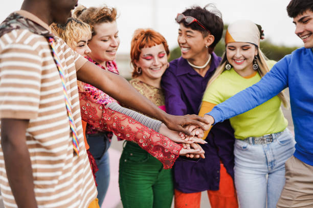 istock Multiethnic friends stacking hands outdoor 1416001702