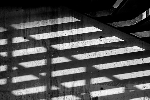 black and white shadow of a stair on the wall