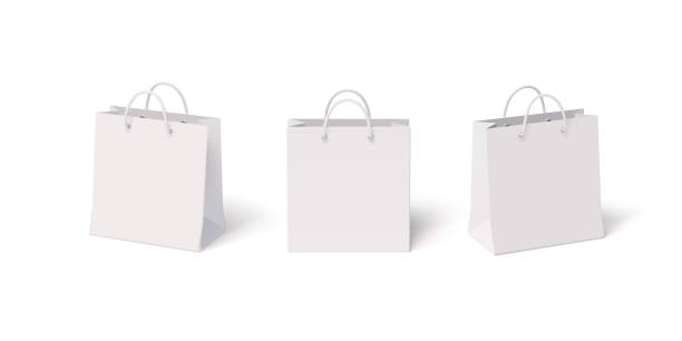 stockillustraties, clipart, cartoons en iconen met set of white paper isolated shopping bags with front and side view. vector realistic 3d blank mockup illustration of packets with plastic handles - shopping bags