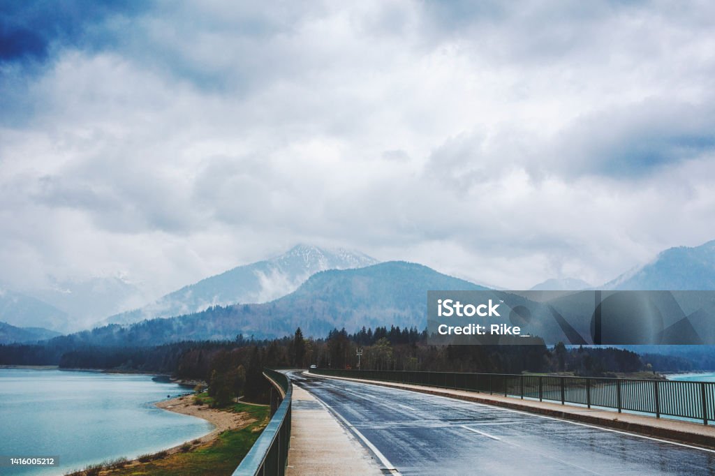 Road over the Sylvenstein reservoir and Isar in Bavaria on a rainy day. Road over the Sylvenstein Lake and Isar in Bavaria on a rainy day. Lake Stock Photo