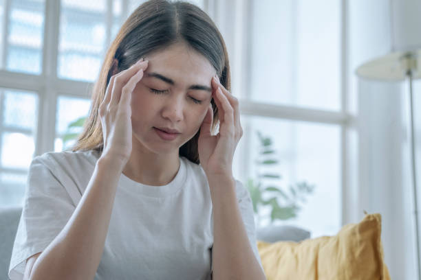 Asian woman have headaches and dizziness, Cerebrovascular disease, Migraine. Asian woman have headaches and dizziness, Cerebrovascular disease, Migraine. headache menstruation pain cramp stock pictures, royalty-free photos & images