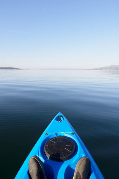 kayak on peaceful calm water on the firth of clyde scotland - loch rowboat lake landscape imagens e fotografias de stock