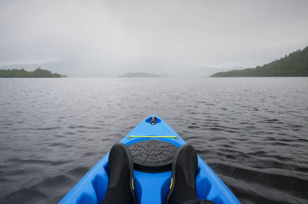 blue kayak on open water at firth of clyde - loch rowboat lake landscape imagens e fotografias de stock