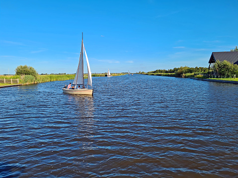 Sailing in the countryside from Friesland in the NEtherlands on a beautiful summer day