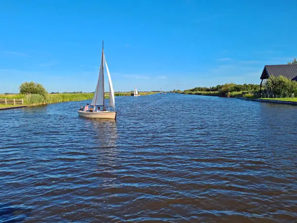 Photo of Sailing in the countryside from Friesland in the NEtherlands on a beautiful summer day
