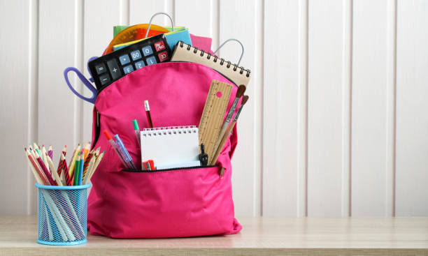 istock Pink school backpack on the desk and stationery. Copy space. 1416014020