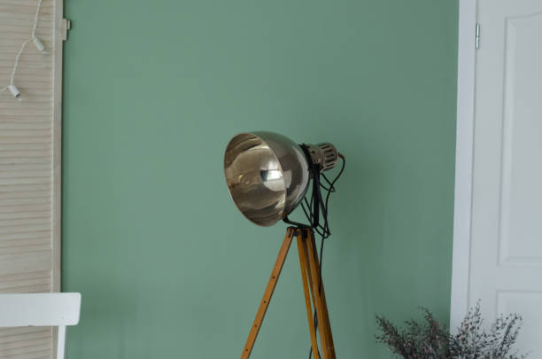 istock Old photo studio lamp. Old style studio light lamp on wall background 1416015709
