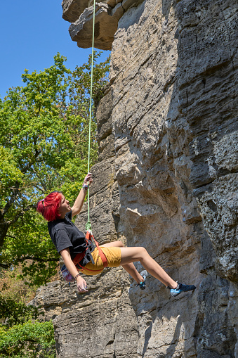 Teenage girl in a difficult rock climbing tour in the Rockgarden in Hessigheim, Neckar valley, Baden-Wuerttemberg, Germany