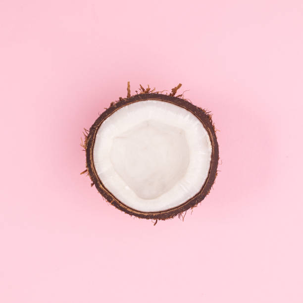 istock Half organic fresh coconut on pastel pink background. Flat lay 1416017925