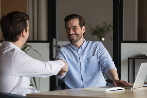 istock Happy two diverse colleagues shaking hands, celebrating making agreement. 1416018686