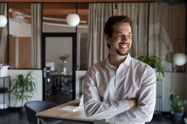 istock Happy motivated young hispanic businessman posing in modern office. 1416018707