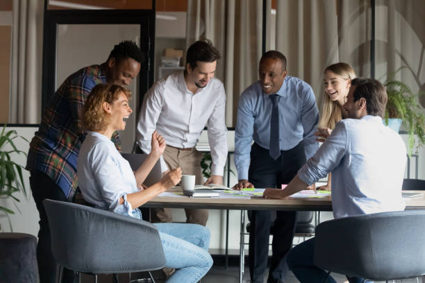 istock Friendly mixed race employees enjoying brainstorming activity in office. 1416019220