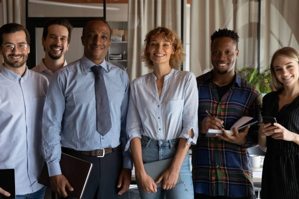 istock Smiling young mixed race business people posing in modern office. 1416019223
