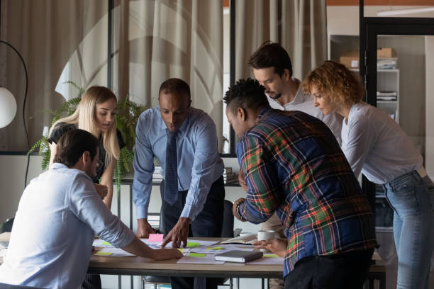 istock Concentrated young mixed race teammates analyzing paper reports. 1416019228