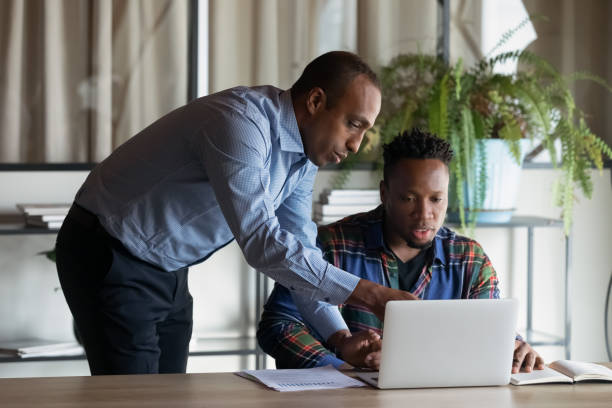 istock Skilled african ethnicity leader coaching multiracial colleague. 1416019261