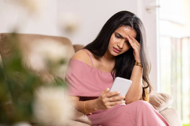 istock Sad young woman using smart phone 1416019682