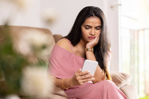istock Sad young woman using smart phone 1416019692