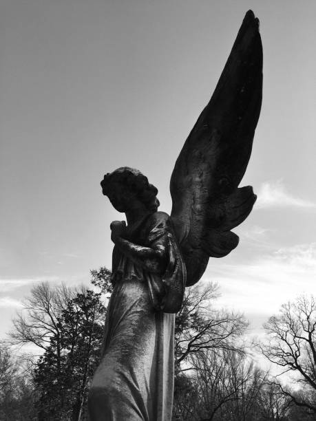 istock Angel tombstone against sky 1416021525