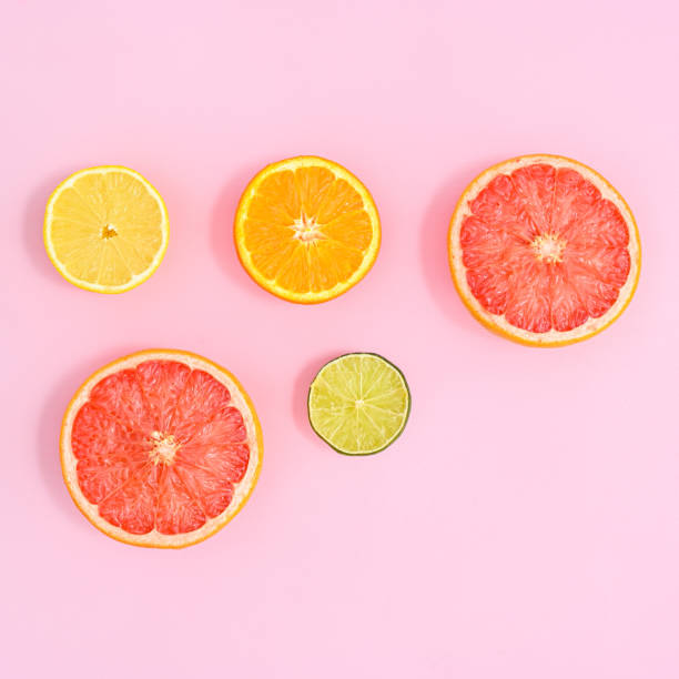 istock Creative layout with sliced citrus fruits on bright pink background. Summer concept. Flat lay 1416022614