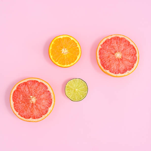 istock Creative layout with sliced citrus fruits on bright pink background. Summer concept. Flat lay 1416022794