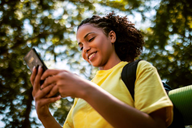 istock African American woman with backpack hiking using phone 1416034367