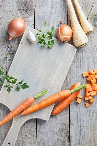 Seasoning on a gray wooden kitchen table, for vegan soup or stew preparation, top view with a free space for copy