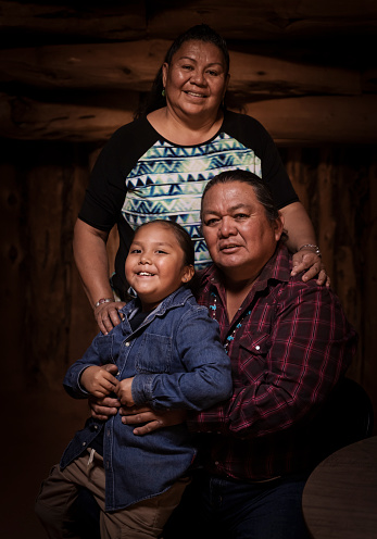 Navajo Family of three portrait on a traditional hogan
