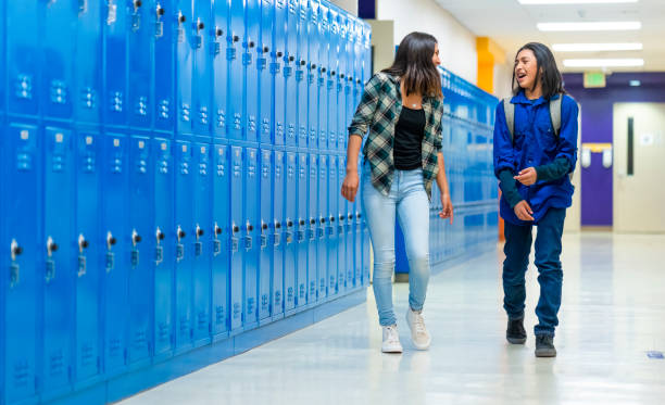 Two High schoolers walking on a corridor Two High schoolers walking on a corridor high school student child little boys junior high stock pictures, royalty-free photos & images