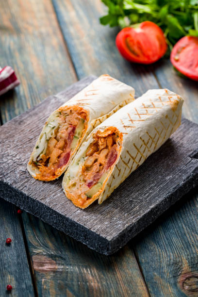 istock roll with chicken and vegetables on the Board, shawarma,shaurma, vertical 1416038882