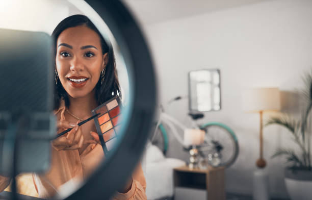 istock Beauty influencer, makeup vlogger and artist filming tutorial at home. Creative cosmetics blogger live streaming, recording webcam broadcast and fun virtual video call online for social media vlog 1416039254