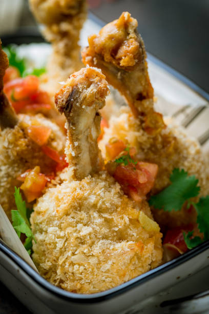 istock fried chicken legs on plate macro close up, vertical 1416039857