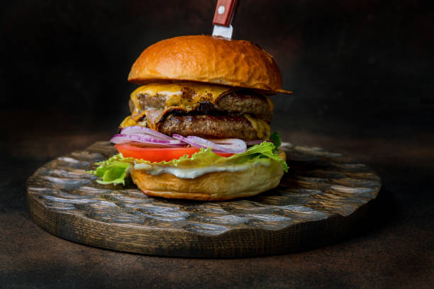 istock A double cheeseburger on the Board on dark brown table 1416040478