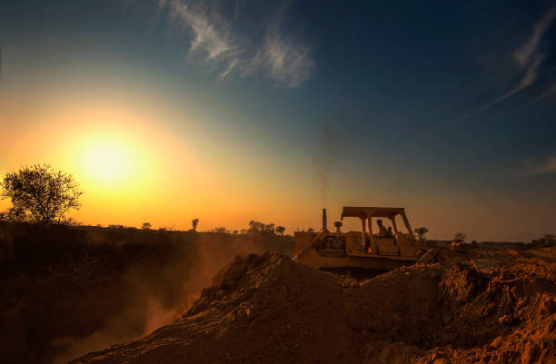 A bulldozer on work earthmoving, soil removing, earth working A bulldozer on work earthmoving, soil removing, earth working shipping heavy agricultural machinery stock pictures, royalty-free photos & images