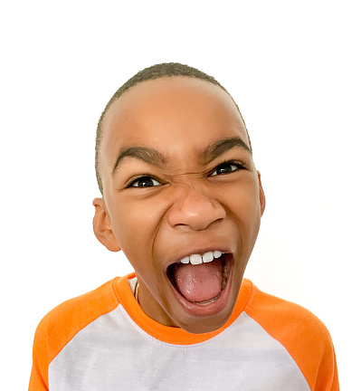 Young black male making a dramatic, yelling facial expression.