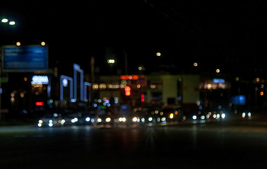 Abstract bokeh background of night street with light cars and street lamps. City life, defocused lights from cityscape, stylish colorful. Concept of stylish urban backgrounds for design. Copy space