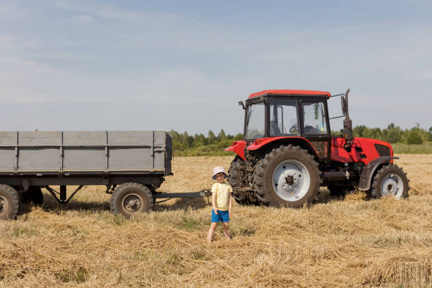istock Child and red tractor with trailer 1416044799